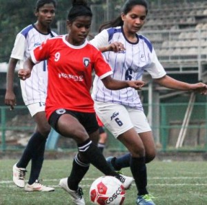 Sasmita Behera (No.9) of PIFA Sports shields the ball from Next Sports Academy players